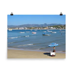 Beach with vibrant blues, boats, and mountains behind - Print